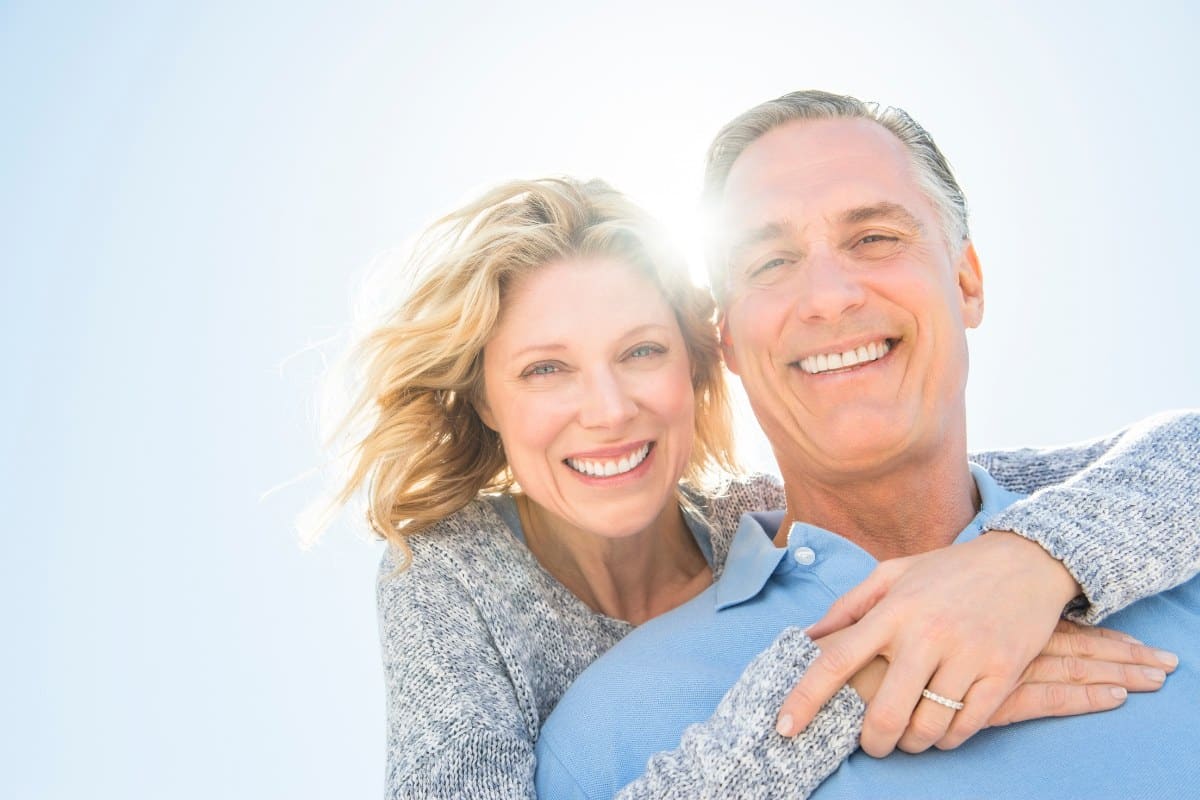 Smiling couple with healthy, confident smiles after oral cancer screenings at tuckahoe creek dental in richmond, va.