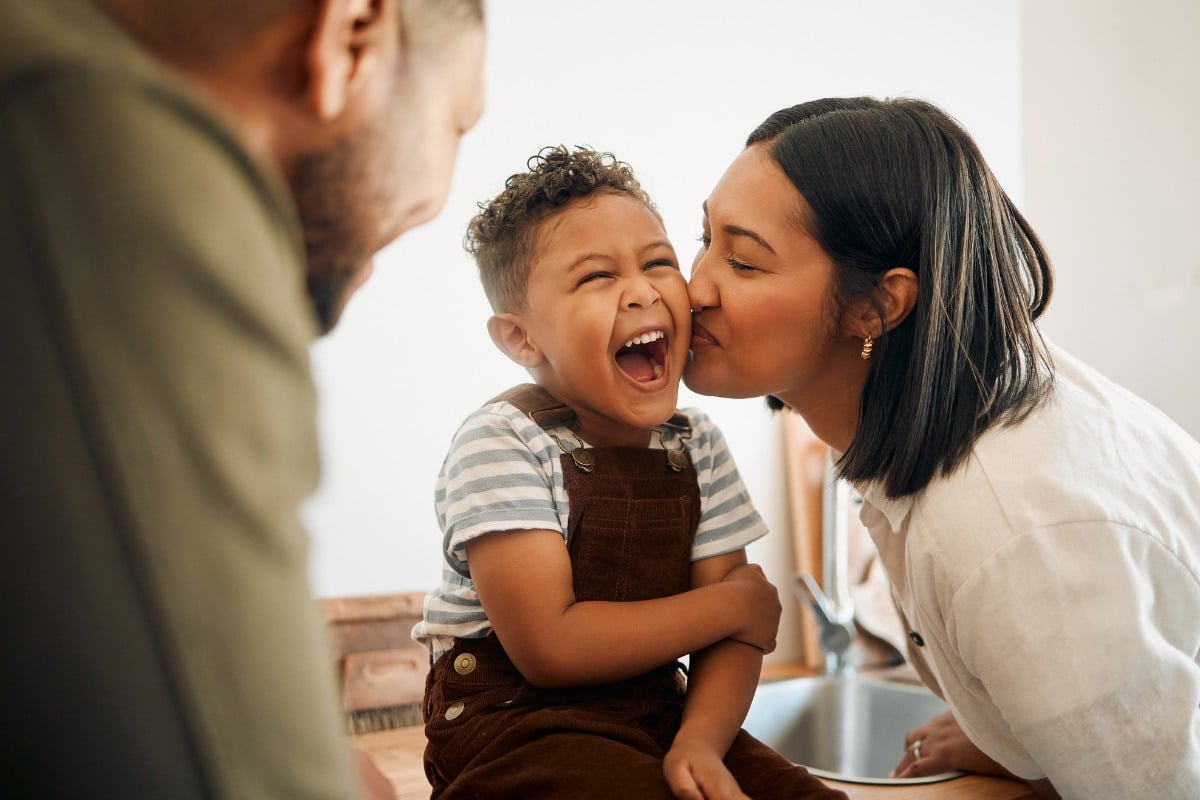 Mother kissing her son on the cheek showcasing the family friendly environment at tuckahoe family dental. Choose us for great care!